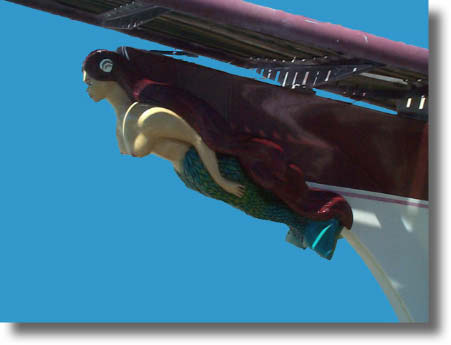 Finished hand carved figurehead mounted on boat